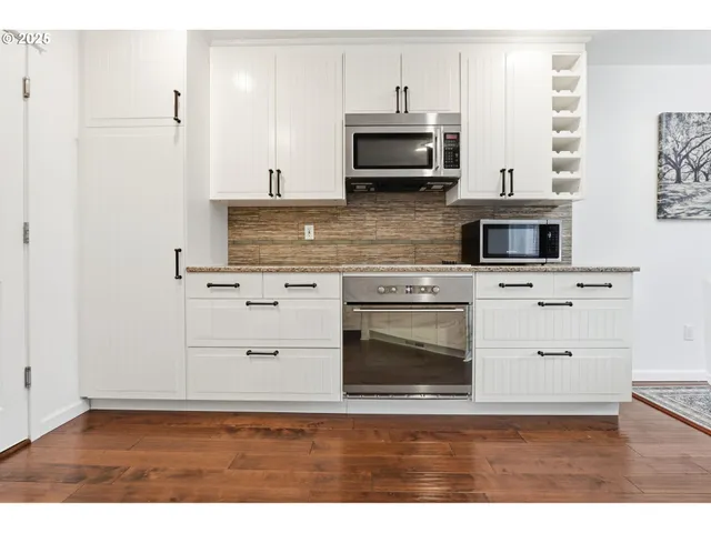 a kitchen with stainless steel appliances a stove microwave and refrigerator