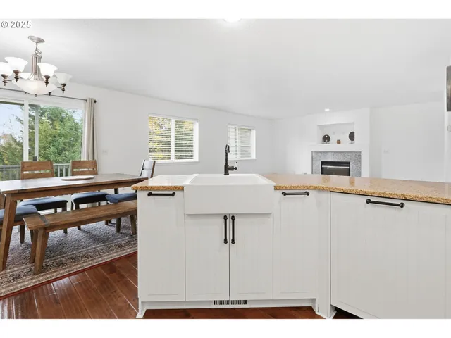 a living room with furniture a window and wooden floor