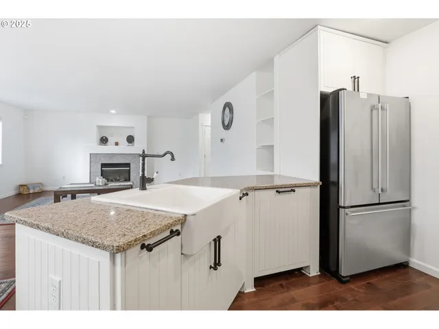 a kitchen with a refrigerator and a stove top oven