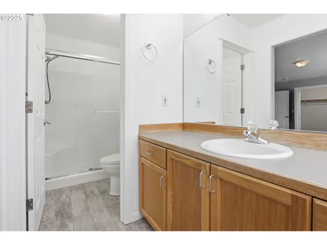 a bathroom with a sink toilet a mirror and shower