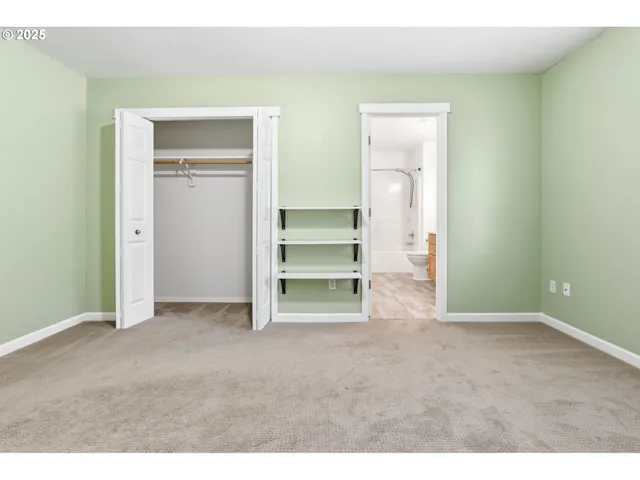 a view of an empty room with a closet
