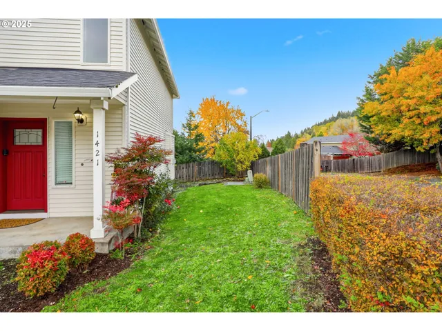 a view of a house with a backyard and a garden