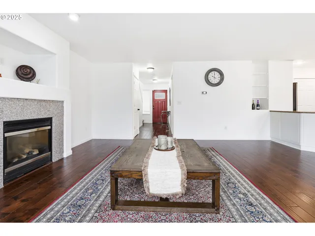 a living room with kitchen island furniture and a fireplace