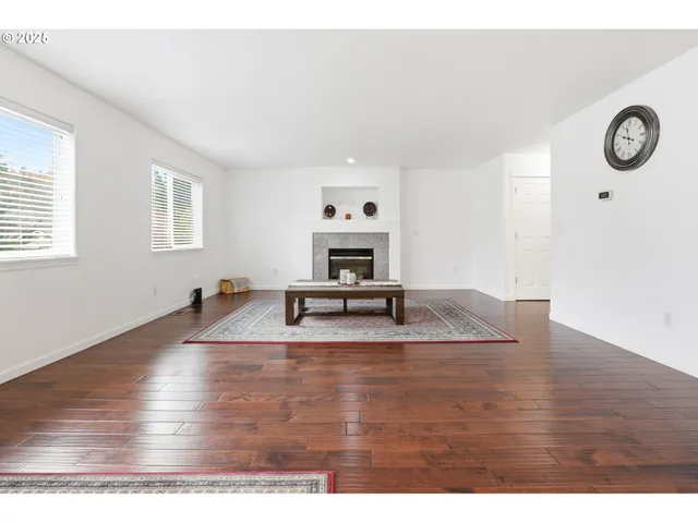 a view of a room with wooden floor