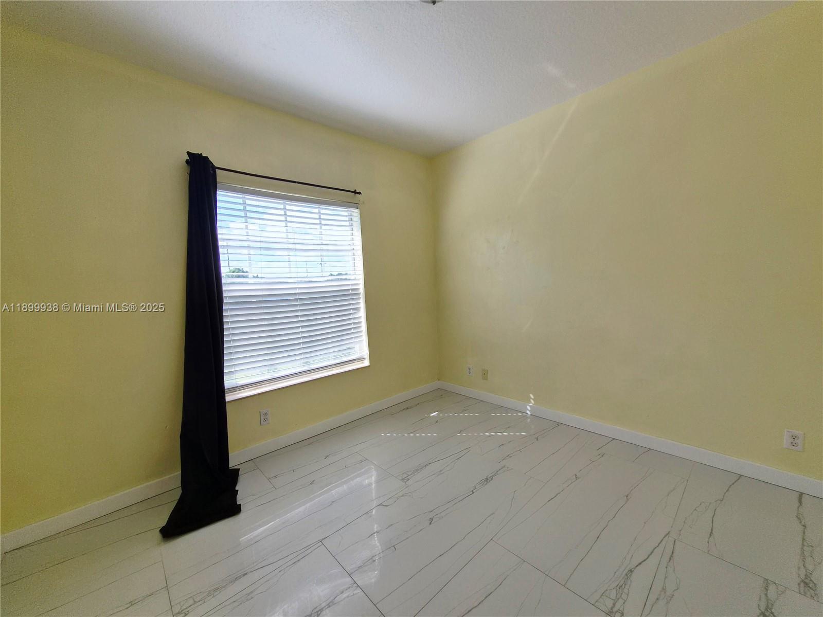 1209 Northwest 27th Avenue Pompano Beach, FL 33069 - Photo 11 of 22 a view of an empty room with a window