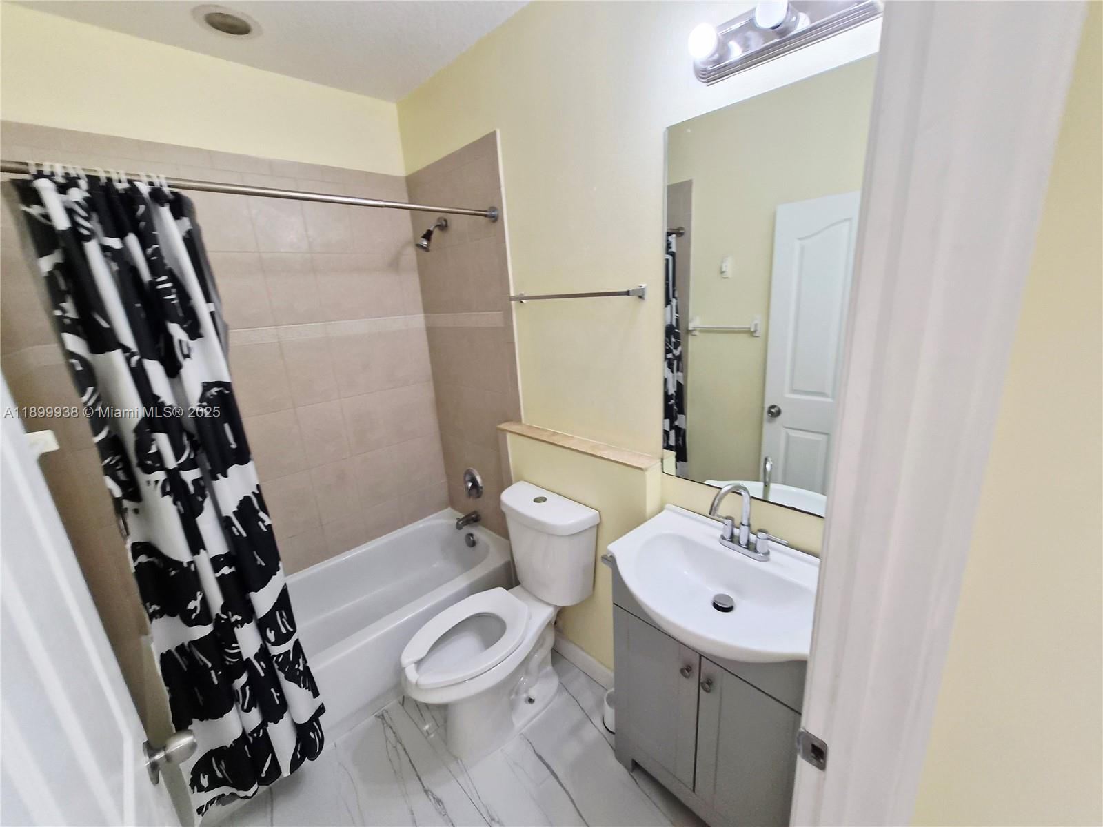 1209 Northwest 27th Avenue Pompano Beach, FL 33069 - Photo 14 of 22 a bathroom with a sink toilet and shower