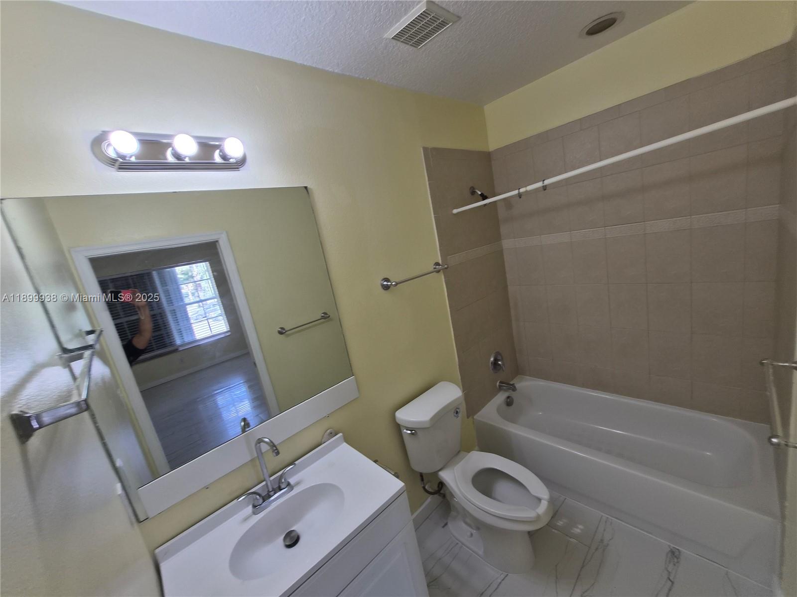 1209 Northwest 27th Avenue Pompano Beach, FL 33069 - Photo 22 of 22 a bathroom with a granite countertop toilet sink and mirror