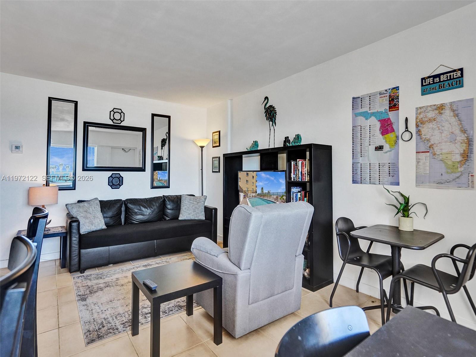 1815 North Surf Road, Unit 202 Hollywood, FL 33019 - Photo 15 of 32 a living room with furniture and a wooden floor