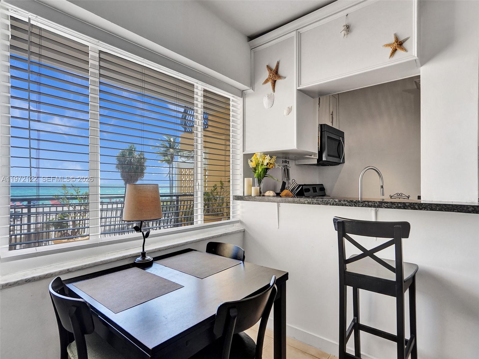 1815 North Surf Road, Unit 202 Hollywood, FL 33019 - Photo 18 of 32 a view of kitchen and dining area with furniture