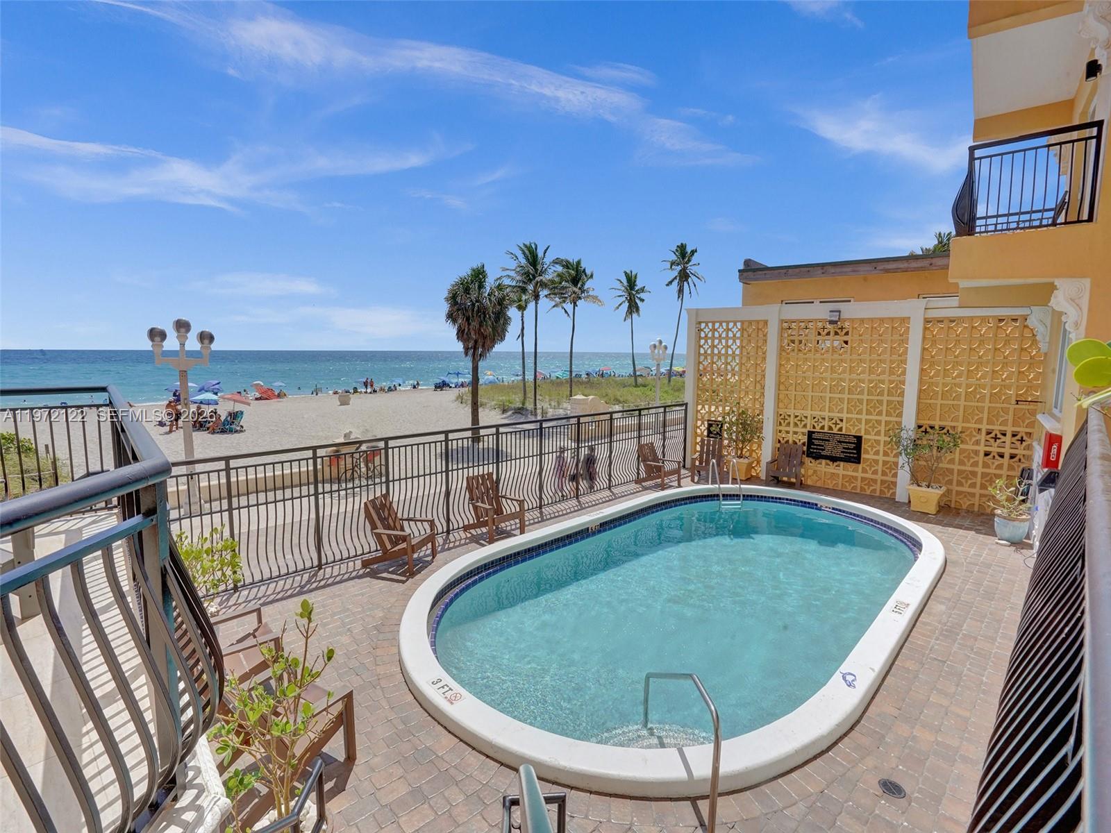 1815 North Surf Road, Unit 202 Hollywood, FL 33019 - Photo 26 of 32 a view of a swimming pool with an outdoor seating