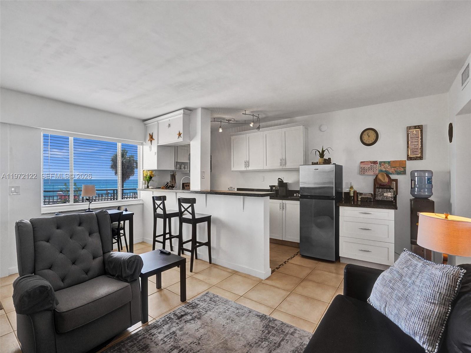 1815 North Surf Road, Unit 202 Hollywood, FL 33019 - Photo 5 of 32 a living room with furniture and kitchen view