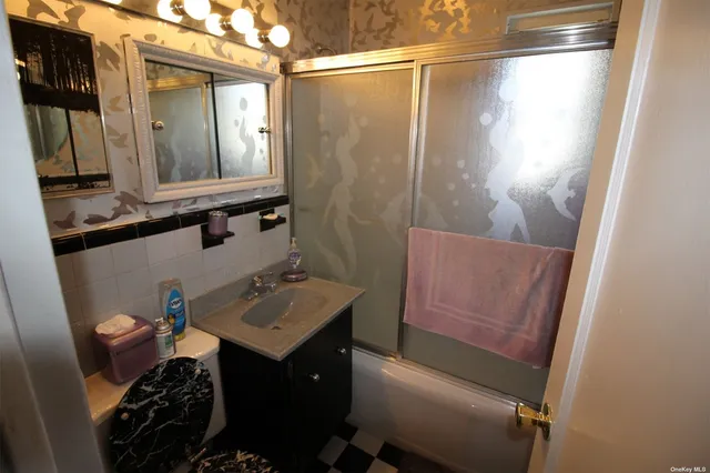 a bathroom with a sink vanity and a mirror