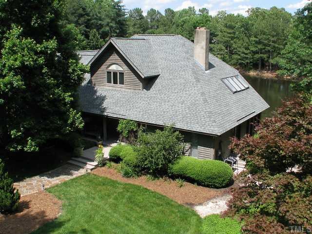 a aerial view of a house with a yard and potted plants