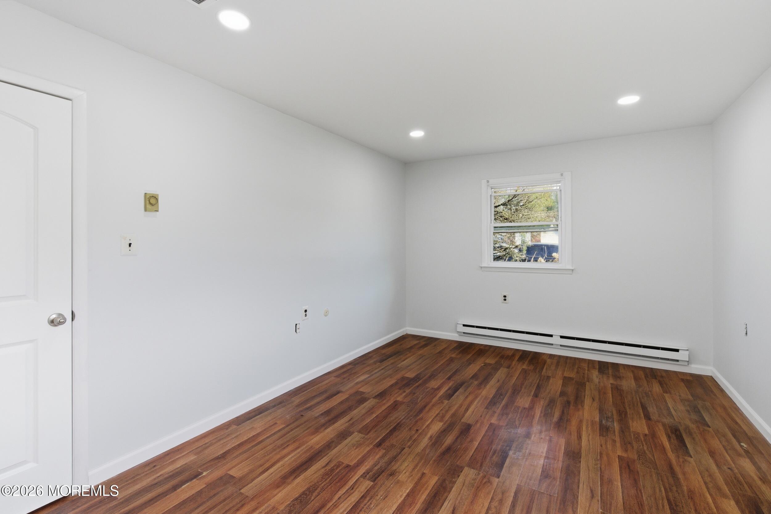 93 Baser Lane Brick, NJ 08724 - Photo 13 of 21 a view of empty room with wooden floor and fan