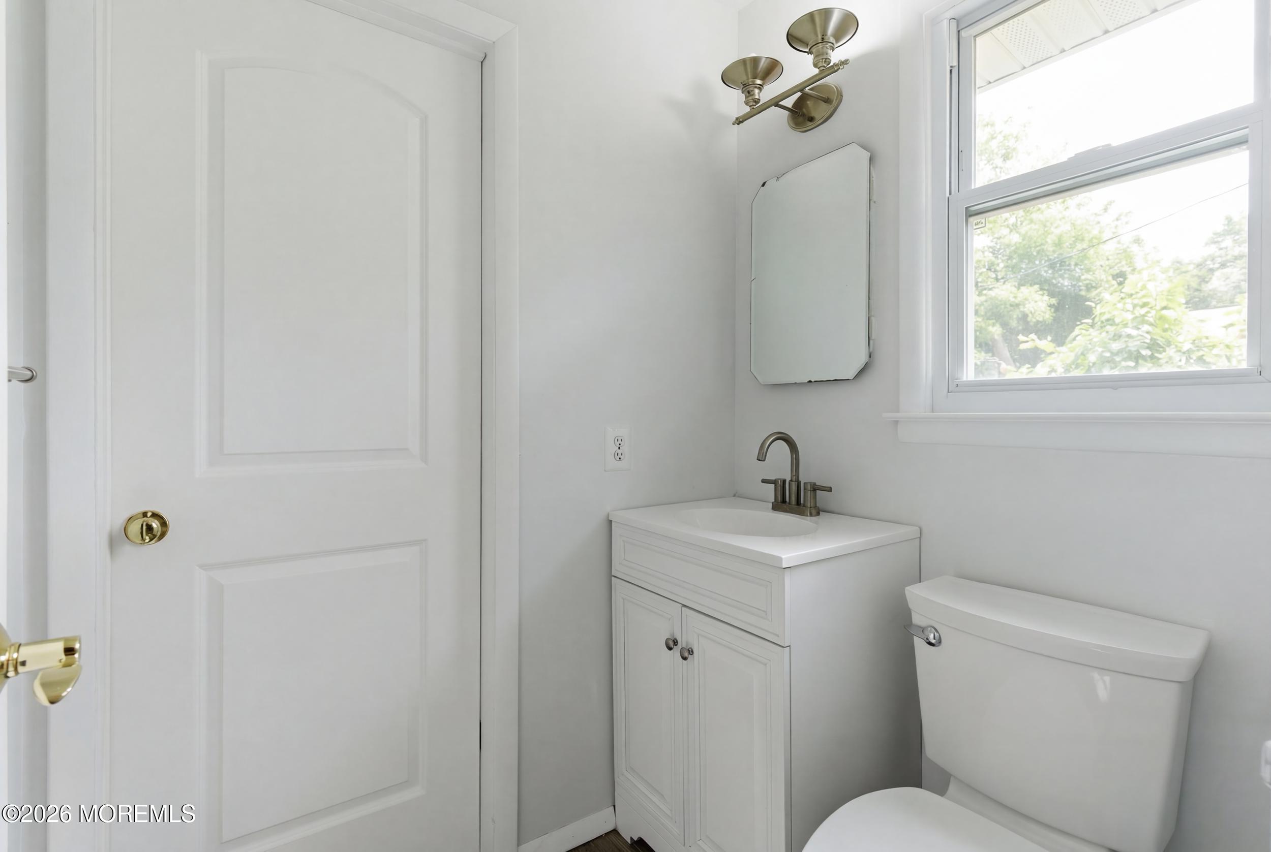 93 Baser Lane Brick, NJ 08724 - Photo 14 of 21 a bathroom with a toilet sink and mirror