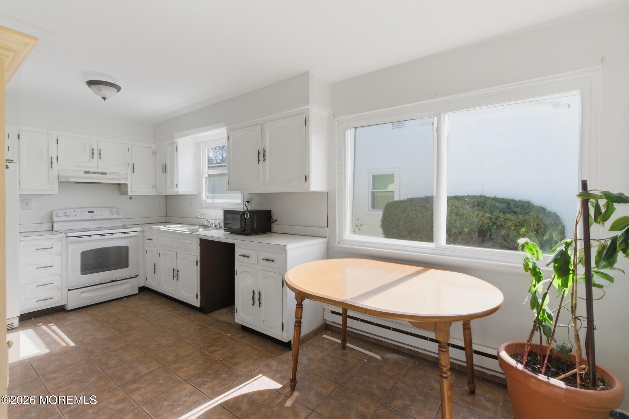 93 Baser Lane Brick, NJ 08724 - Photo 7 of 21 a kitchen with white cabinets and white appliances