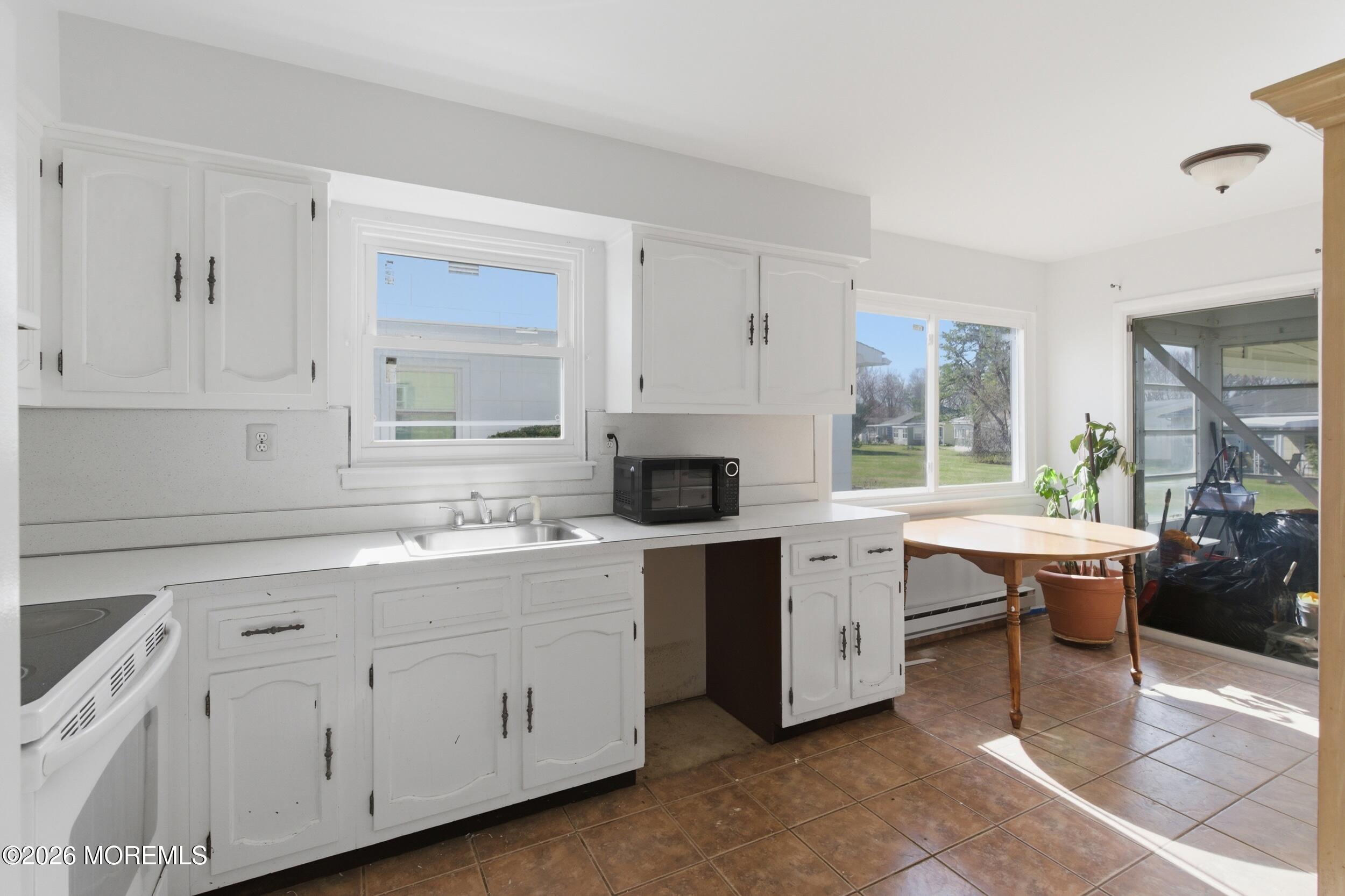 93 Baser Lane Brick, NJ 08724 - Photo 8 of 21 a kitchen with a sink stove and cabinets
