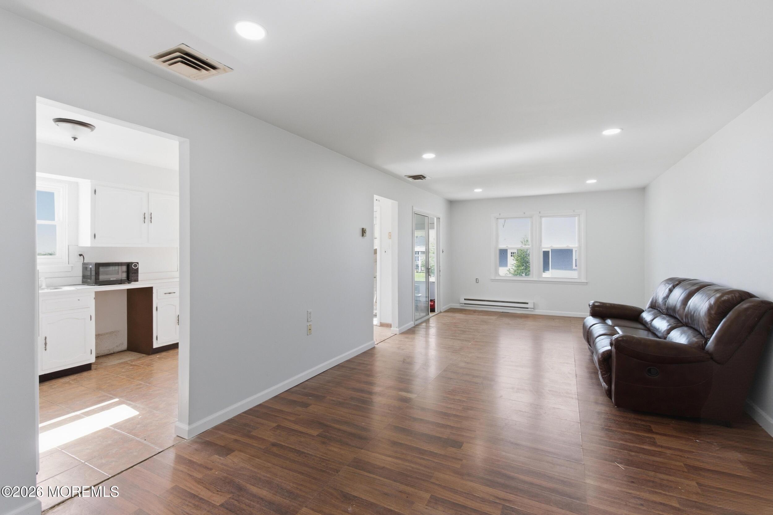 93 Baser Lane Brick, NJ 08724 - Photo 9 of 21 a view of a livingroom with furniture and wooden floor