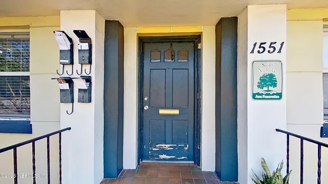 a view of a hallway with wooden floor and entryway