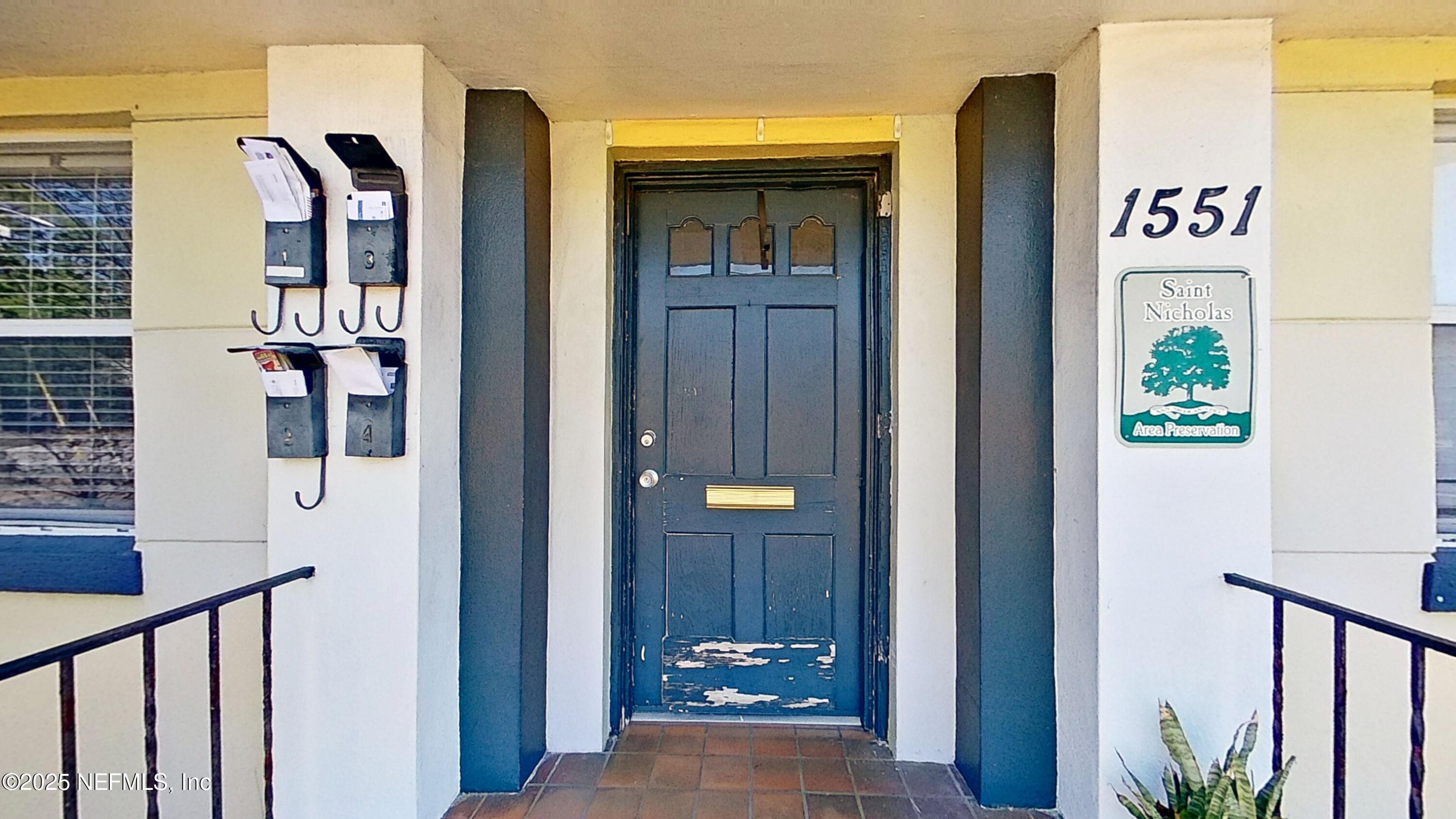 a view of a hallway with wooden floor and entryway
