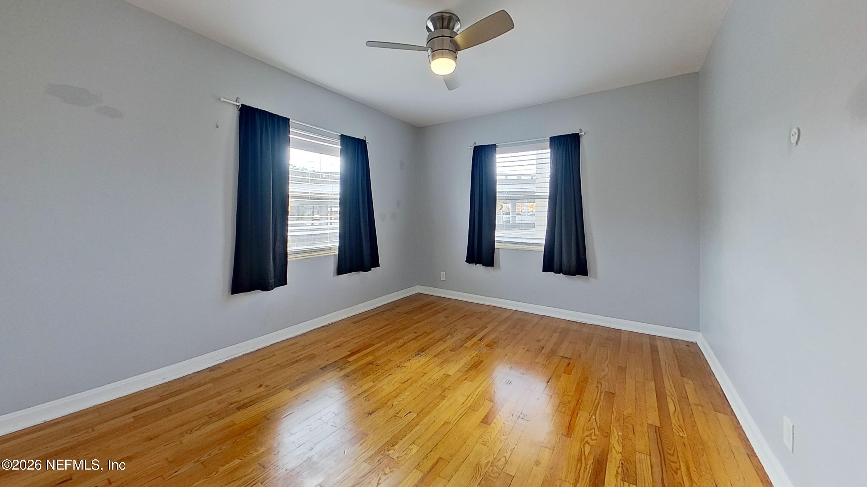 1551 Nicholson Road, Unit 2 Jacksonville, FL 32207 - Photo 7 of 19 a view of an empty room with a window and wooden floor