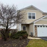 a front view of house with yard and trees