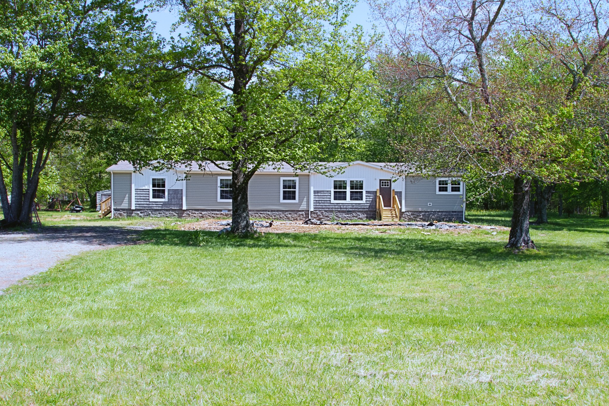 a front view of a house with a garden and deck