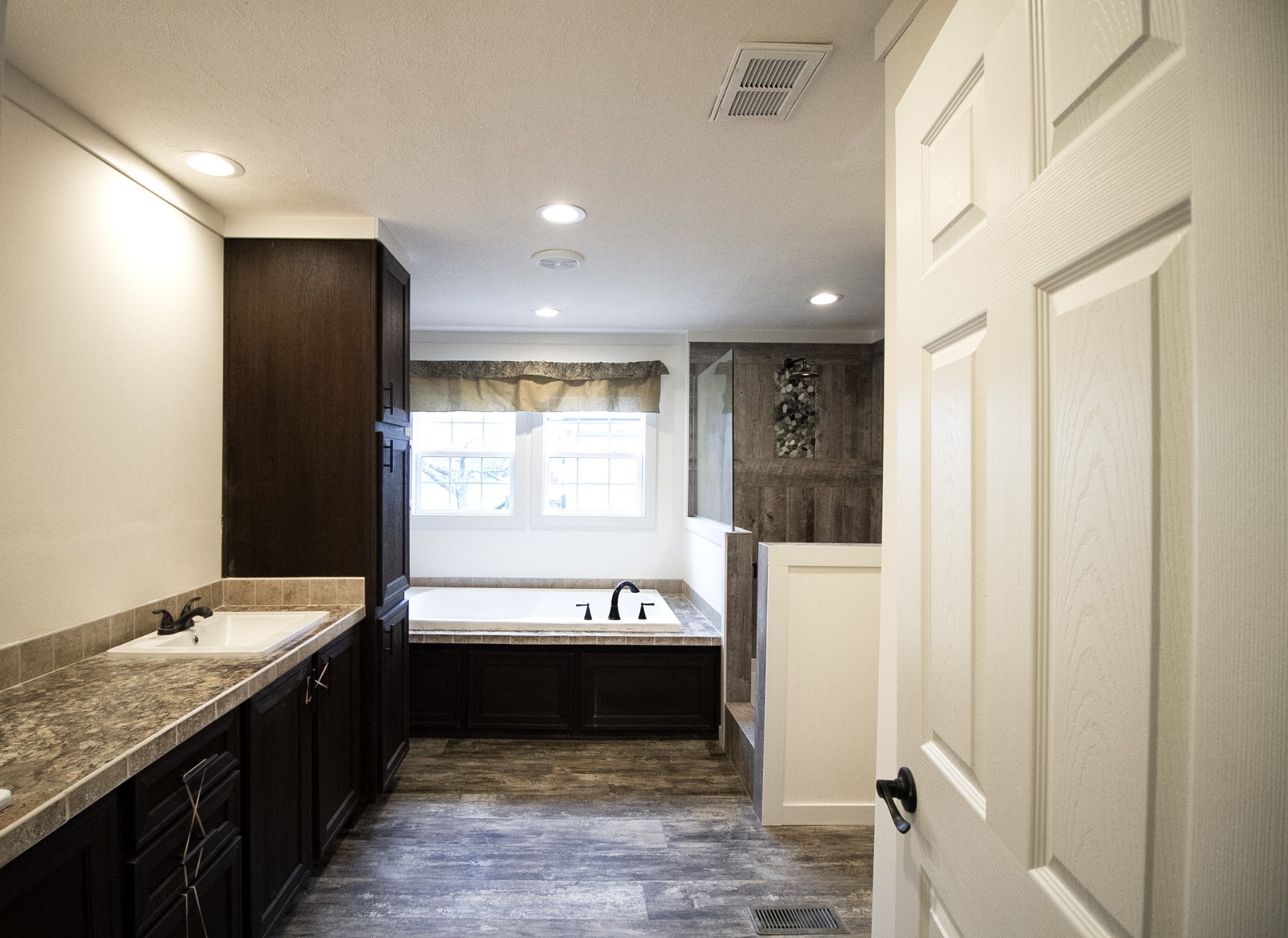 2555 Liverpool Road Woodlawn, TN 37191 - Photo 11 of 21 a large bathroom with a tub a double vanity sink and mirror