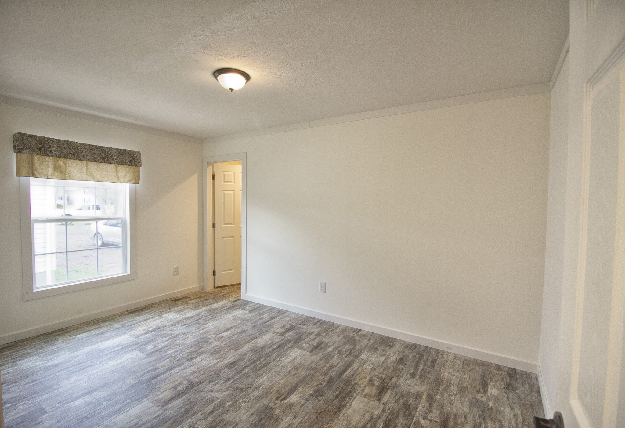 2555 Liverpool Road Woodlawn, TN 37191 - Photo 15 of 21 an empty room with window and hardwood floor