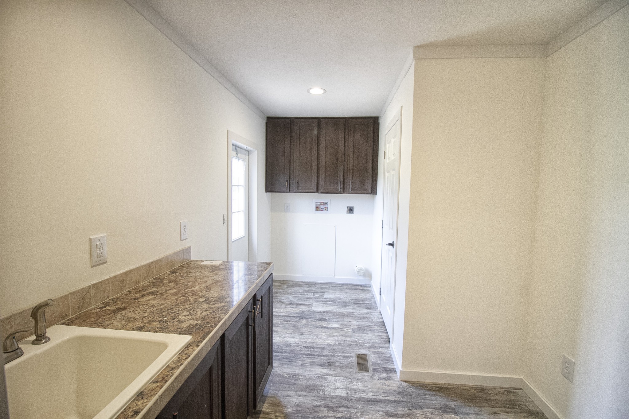 2555 Liverpool Road Woodlawn, TN 37191 - Photo 18 of 21 a kitchen with granite countertop a sink and a refrigerator