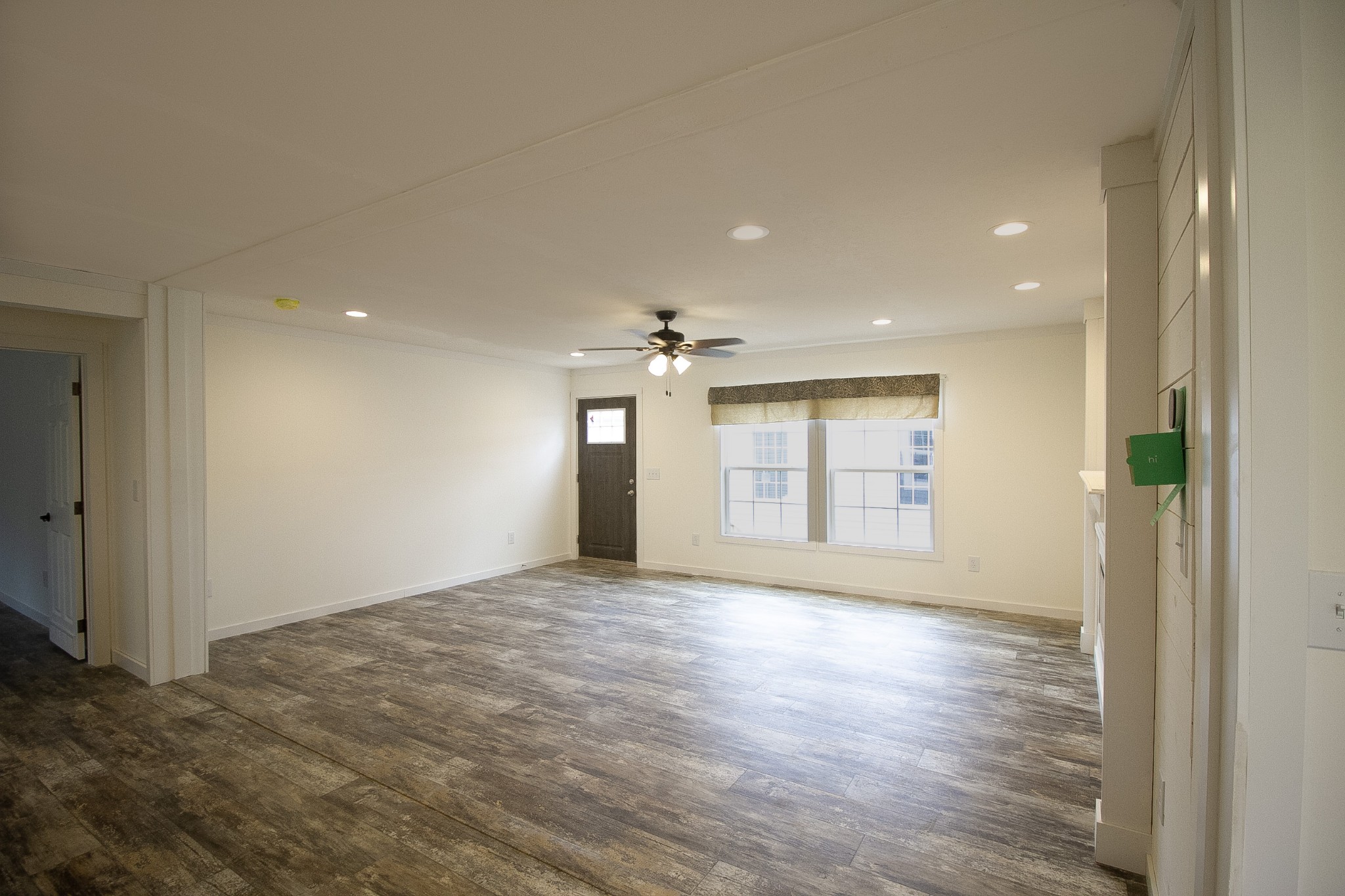 2555 Liverpool Road Woodlawn, TN 37191 - Photo 3 of 21 a view of an empty room with window and wooden floor