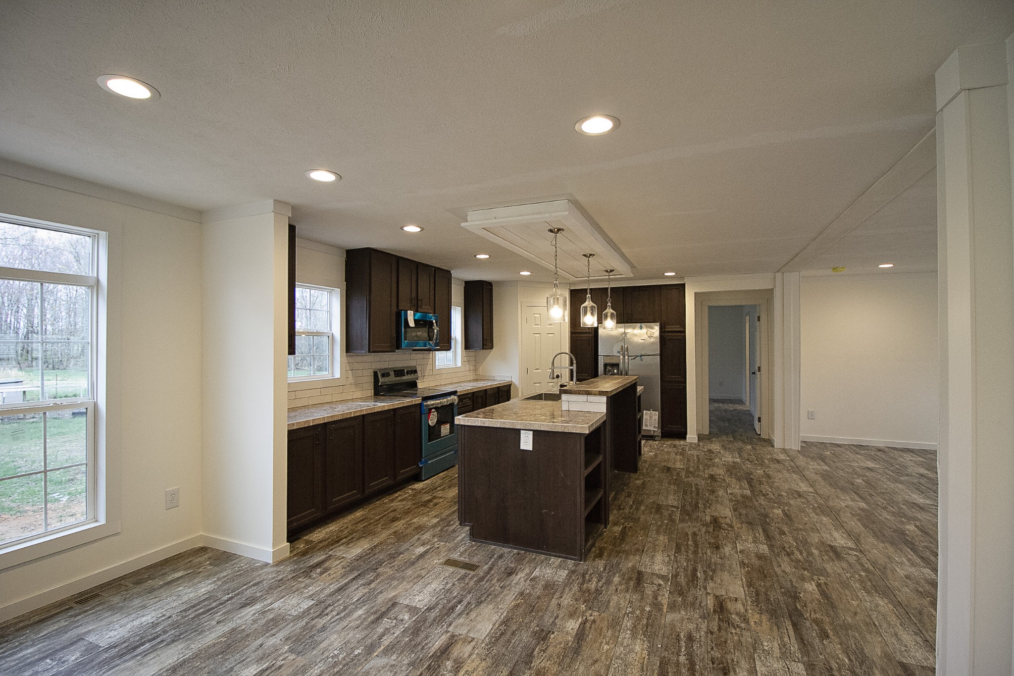 2555 Liverpool Road Woodlawn, TN 37191 - Photo 4 of 21 a large kitchen with kitchen island a sink a stove and a refrigerator