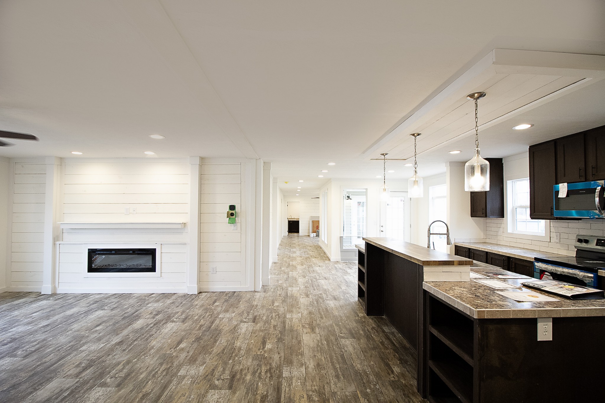 2555 Liverpool Road Woodlawn, TN 37191 - Photo 7 of 21 a kitchen with granite countertop a stove top oven a sink dishwasher and a fireplace with wooden floor