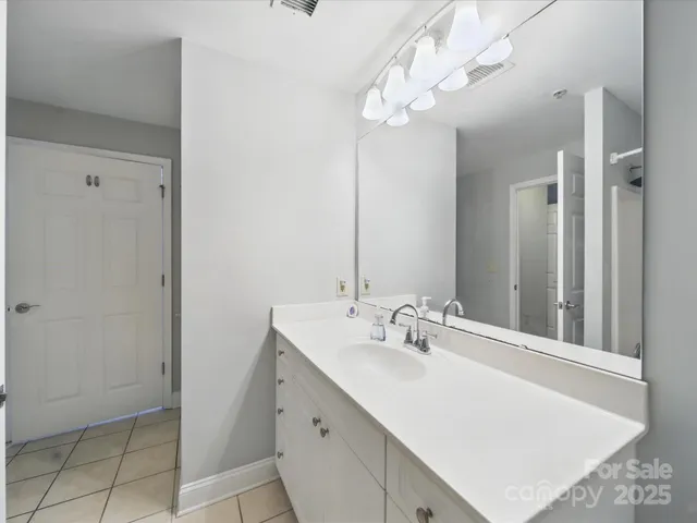 a bathroom with a sink vanity and a mirror