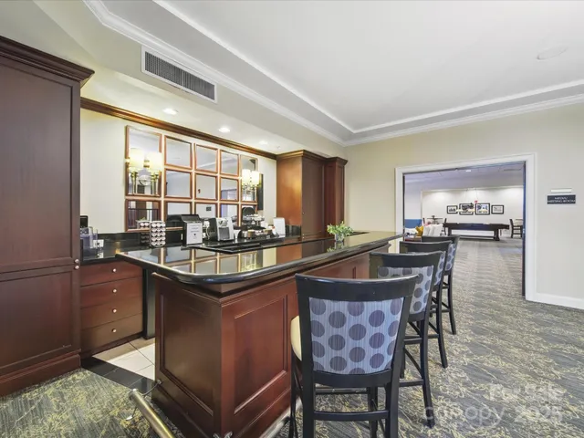 a kitchen with granite countertop sink stove and dining table