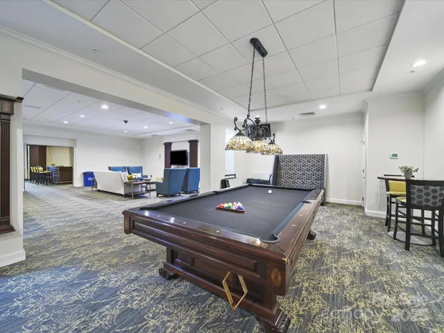 a living room with furniture a table and chairs