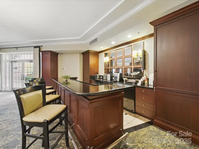 a kitchen with a sink and chairs