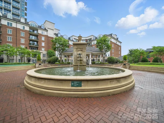 a view of a white building among the street with buildings