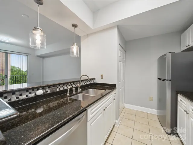 a kitchen with a sink and refrigerator