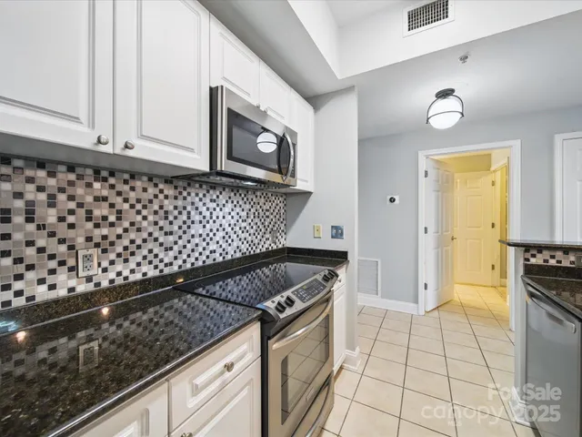 a kitchen with granite countertop a stove and a sink