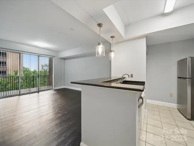 a kitchen with granite countertop a sink and a stove top oven