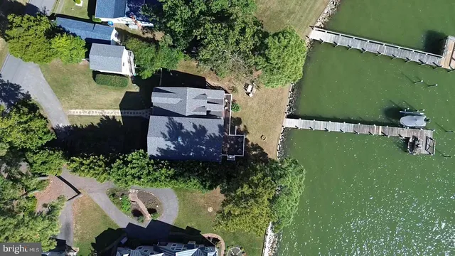 a large kitchen with a large counter top a sink a window and stainless steel appliances