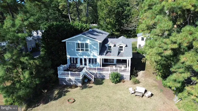 an aerial view of a house with table and chairs under an umbrella