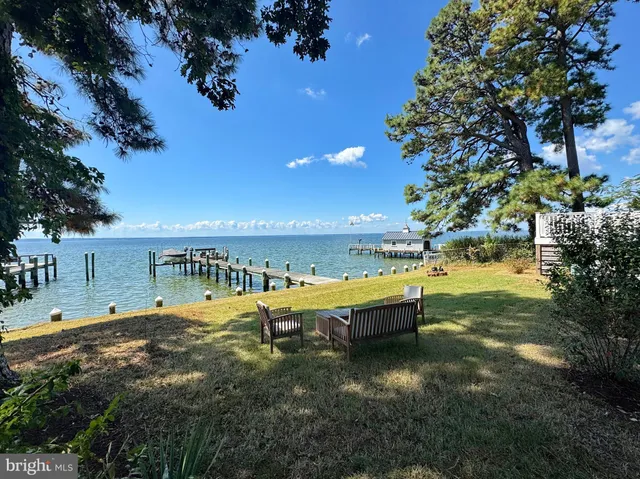 a view of a house with swimming pool and sitting area
