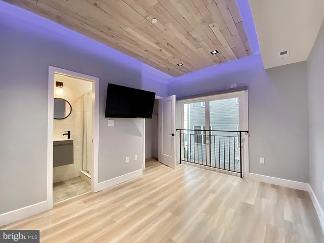 a view of a room with wooden floor