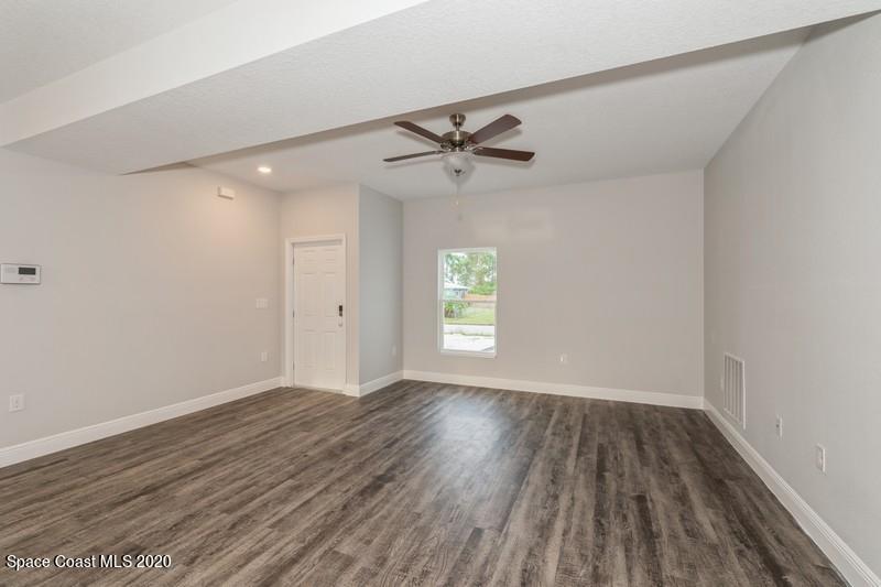 3231 Telesca Road Southeast Palm Bay, FL 32909 - Photo 4 of 17 03_1462LeewardAvenue_10001_LivingRoom_Fl