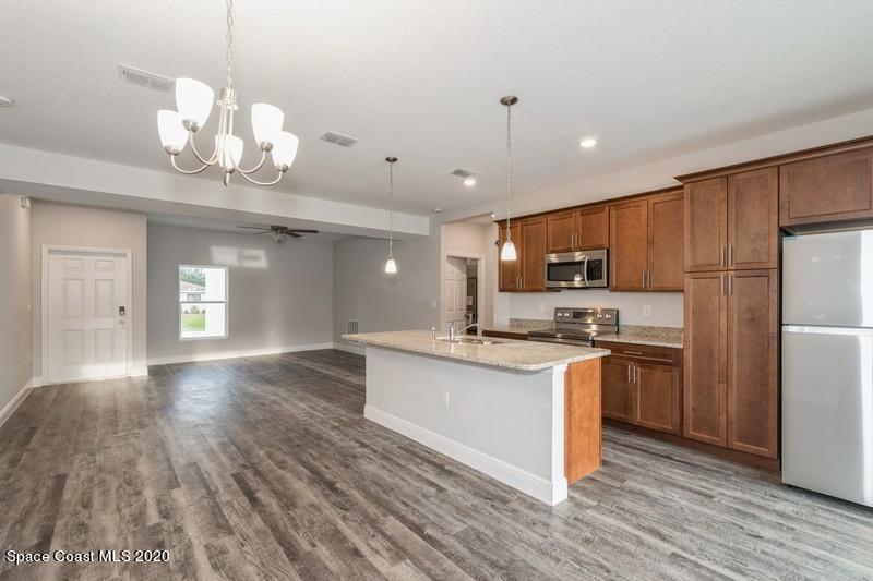 3231 Telesca Road Southeast Palm Bay, FL 32909 - Photo 6 of 17 05_1462LeewardAvenue_92_KitchenDiningRoo