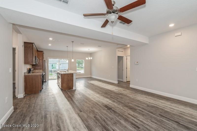 3231 Telesca Road Southeast Palm Bay, FL 32909 - Photo 8 of 17 06_1462LeewardAvenue_91_KitchenLivingRoo