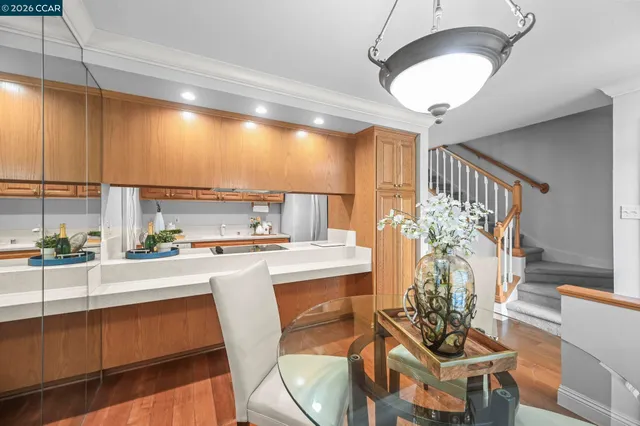 a kitchen with a table chairs stove and cabinets