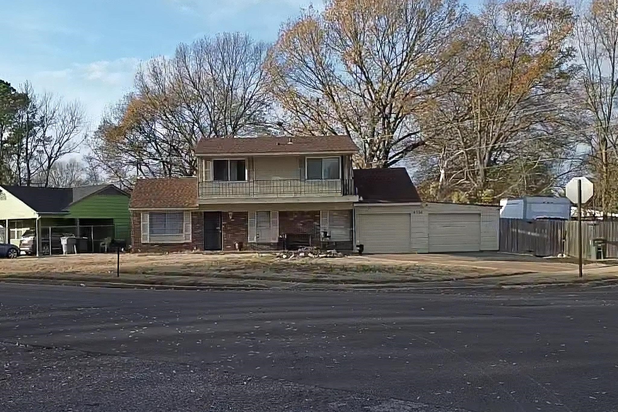 Traditional-style house featuring a balcony, driveway, and a garage